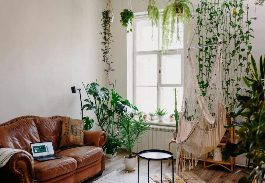 Living room interior with a variety of potted plants on the floor, shelves, and coffee table